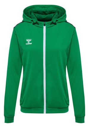 Veste à capuche zippée verte avec une finition texturée, fermeture éclair blanche et accents noirs aux épaules. Dotée d'une capuche et de poches latérales. Logo de la marque affiché.