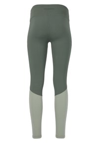 Olivgröna leggings med hög midja, med ljusgröna detaljer vid nederbenen och flatlock-sömmar för komfort.