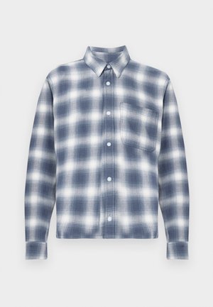Plava i bijela karirana flanel košulja s dugim rukavima, prednjim kopčanjem na gumbe, ovratnikom i jednim džepom na prsima. Mekana tekstura, ležerni dizajn.