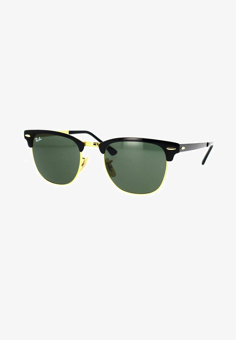 Occhiali da sole Ray-Ban con montatura nera, lenti verdi e dettagli dorati. Design classico con una forma audace e sopracciglia ben definite.