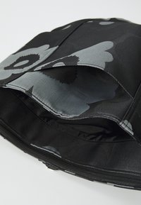 Black fabric bag featuring a floral pattern in shades of gray, with a smooth texture and a zippered compartment. Interior shows lining.