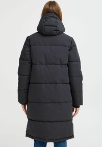 Mørk grå jakke med hette, med en quiltet design, lange ermer og en rett fasong som når midten av låret.