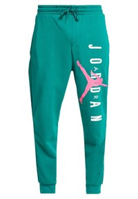 Teal joggers av mjukt tyg, med en stor rosa "Jordan"-logotyp och silhuettgrafik på högra benet; elastisk midja.