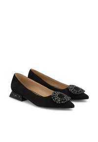 Ballerine in suede nero con punta affusolata, caratterizzate da un'elegante decorazione in cristallo nero sulla tomaia e un tacco basso a blocco con perline.