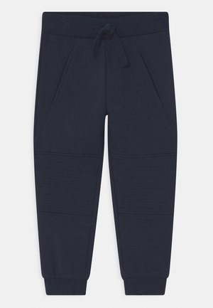 Pantalon de jogging bleu marine avec taille et poignets côtelés, fermeture par cordon de serrage, poches latérales et détails cousus au niveau des genoux.