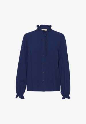 Marineblauwe blouse met een rimpelboord en een knoopsluiting aan de voorkant. Lange mouwen met gatherings aan de manchet. Gemaakt van een gladde, lichte stof.