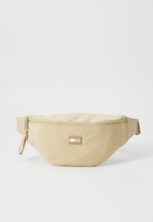 Marsupio in nylon beige con chiusura zip e una piccola placca con logo. Forma leggermente arrotondata con una tracolla staccabile. Texture liscia.