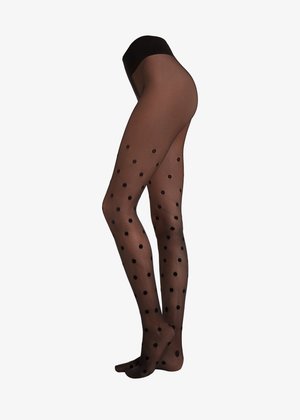 Tights negros con lunares hechos de material transparente, con una cintura alta, que presentan grandes patrones circulares a lo largo de las piernas.