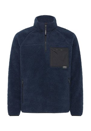 Granatowy polarowy polar z wysokim kołnierzem, zamkiem z przodu i czarną kieszenią naszytą. Ma miękką teksturę i boczne kieszenie na zamek.