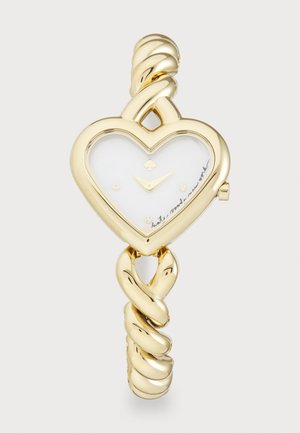 Montre en forme de cœur doré avec un cadran blanc, design de bracelet torsadé, et petits accents décoratifs. Présente des index horaires minimalistes.