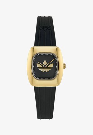 Čierny gumový remienok na hodinky so zlatým štvorcovým puzdrom. Čierny ciferník obsahuje zlaté logo Adidas a hodinové indexy. Hladký povrch, minimalistický dizajn.