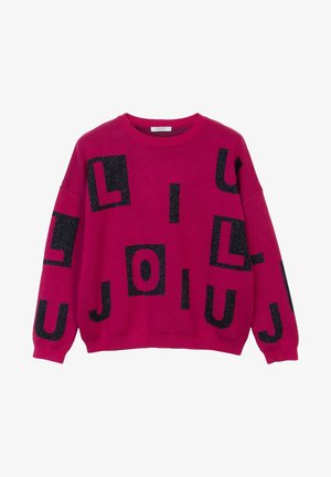 Bright pink sweater with black glittery block letters scattered across the front and sleeves in a casual, loose fit design.