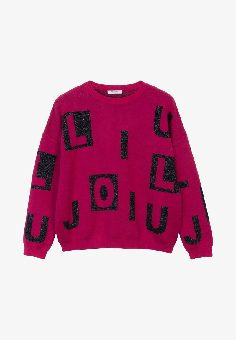 Pull rose vif avec des lettres noires pailletées dispersées sur le devant et les manches dans un design décontracté et ample.