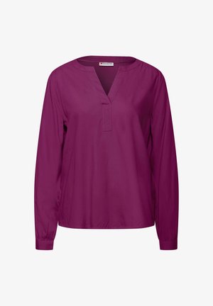 Bluzka z długim rękawem, w dekolcie w kształcie litery V, wykonana z jednolitego ciemnofioletowego materiału. Miękka tekstura, luźny krój i subtelne marszczenia przy mankietach.