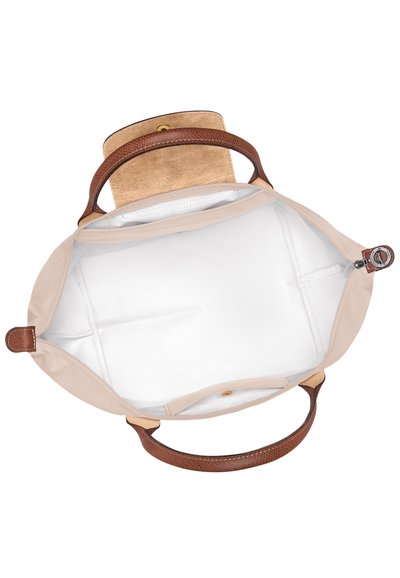 Beige tote bag with a smooth fabric body, textured brown leather handles, and a suede interior, featuring a button closure and no visible compartments.