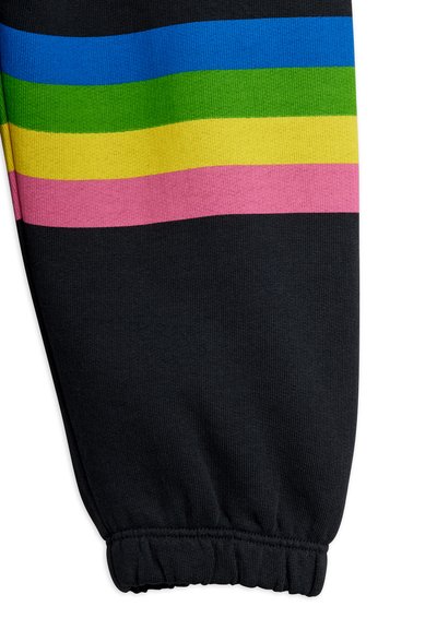 Μανίκι μαύρου ρούχου με ελαστικό τελείωμα και οριζόντιες ρίγες σε μπλε, πράσινο, κίτρινο και ροζ κοντά στην περιοχή του ώμου.