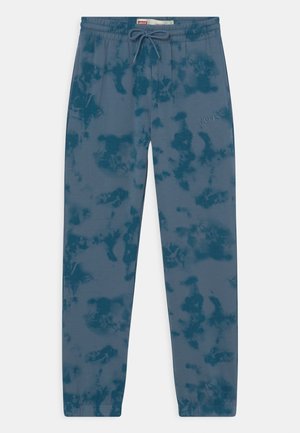 Niebieskie spodnie dresowe w stylu tie-dye z elastyczną talią i mankietami, wiązaniem na sznurek oraz subtelnym logo Levi’s na prawej udzie.