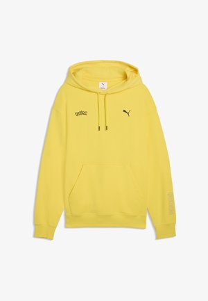 Yellow hooded sweatshirt with front pocket, black Puma logo on right chest, Pokémon logo on left chest, and "#0025" on left sleeve.