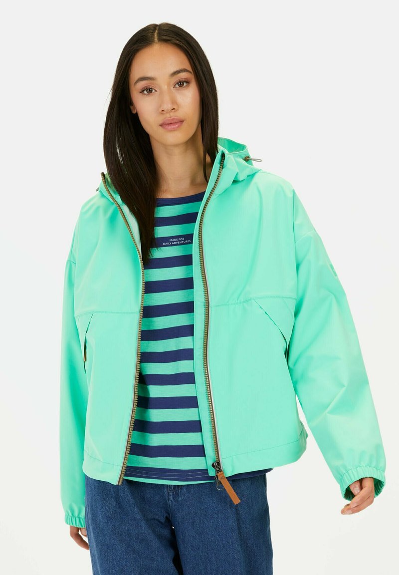 Lichtblauwe waterdichte jas met rits en capuchon, gecombineerd met een blauw-groene gestreepte shirt. Casual pasvorm met elastische manchetten.