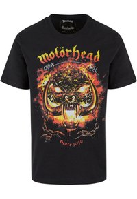 Černé tričko s krátkým rukávem vyrobené z bavlny, s barevným grafickým potiskem lebky s rohy, plameny a textem "Motörhead Overkill Since 1979."