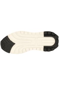 Vit och svart gummiskosula med texturerade mönster, med skåror och kanter för grepp. Observera den kontrasterande färgen vid spetsen.