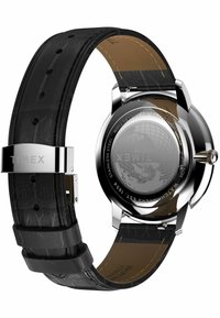 Timex watch with a black embossed leather strap, silver stainless steel case, and textured watch face featuring a globe design on the back.