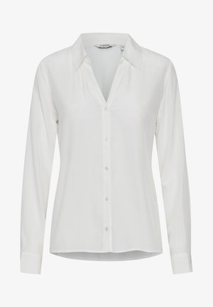 Valge pikakätine nööpidega särk, millel on sisenenud krae, valmistatud siledast kangast, millel on tagasihoidlik sära ja sirge äär.