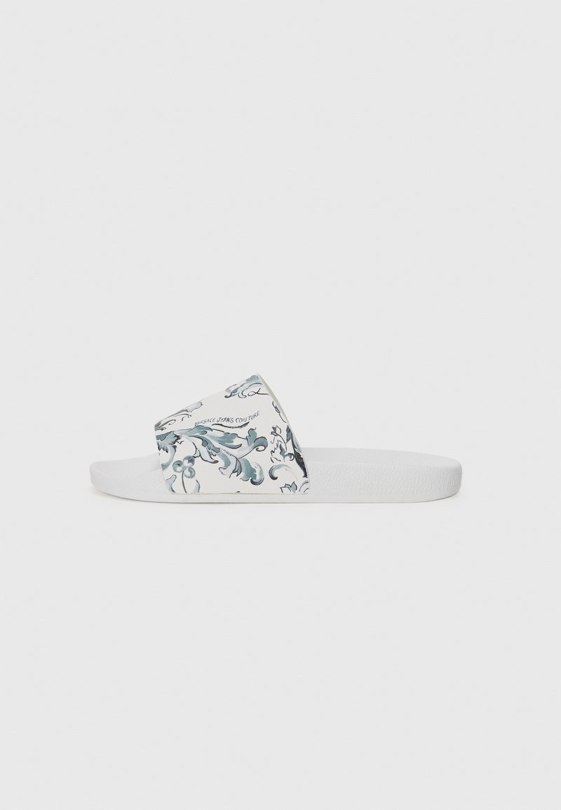 White slide sandal featuring a printed strap with a blue floral and swirl pattern, textured sole, and smooth finish.