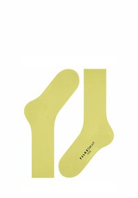 Gelbe Baumwollsocken mit einem nahtlosen Design, gerippten Bündchen und bedrucktem Branding an der Sohle. Besitzen eine glatte Textur und ein leichtes Gefühl.