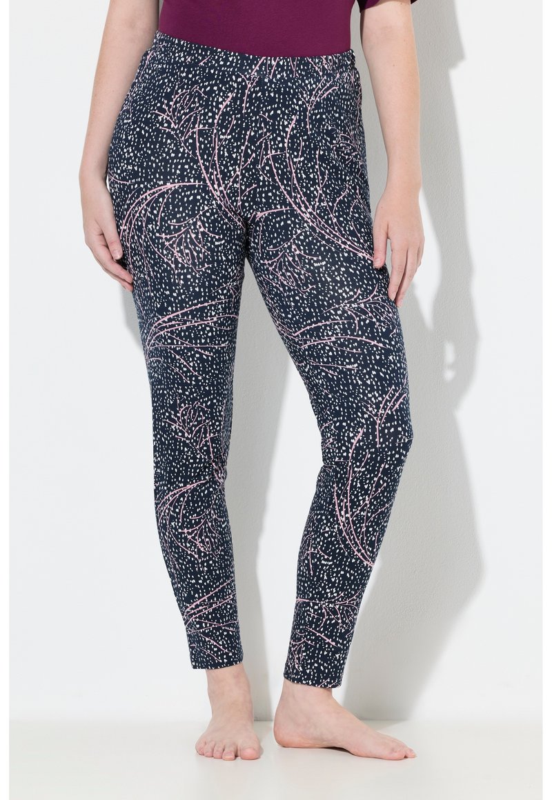 Leggings en color marino con un patrón de flores rosas y puntos. Fabricados con material elástico, cuentan con una cinturilla alta y un ajuste slim.