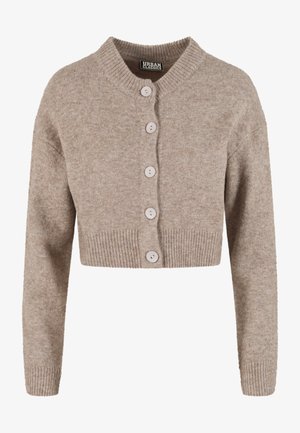 Īss bēšs kardigans no mīksta trikotāžas auduma ar ribotu apakšu, apaļu apkakli un sešām gaismas krāsas pogām priekšpusē.