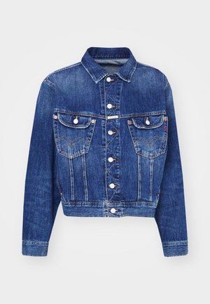 Blue denim jacket with a cropped design, pointed collar, two chest pockets with flaps, silver buttons, and contrasting stitching.