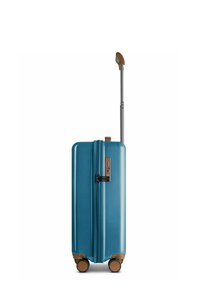 Maleta rígida color teal con cremallera, acentos en bronce, un mango retráctil y cuatro ruedas para maniobrabilidad.