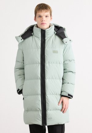 Light green puffer coat with a high collar, black hardware, and a zippered front. Features quilted texture and adjustable cuffs.
