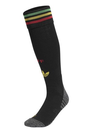 Calzino nero fino al ginocchio con righe rosse, gialle e verdi sul bordo, punta e tallone grigi e un logo giallo vicino alla caviglia.