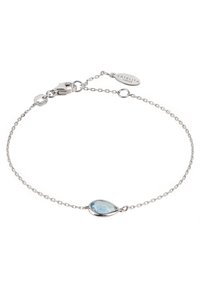 Silver chain bracelet with a teardrop-shaped blue gemstone centerpiece, featuring a secure clasp and a small metallic tag.