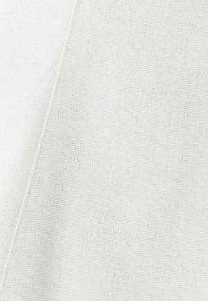 Light beige textured fabric with a subtle weave pattern; features a clean, angled seam and an even, matte finish.
