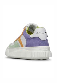Colorful sneaker with a mix of white leather, green, purple, and orange suede accents. Thick white rubber sole with ridged texture.