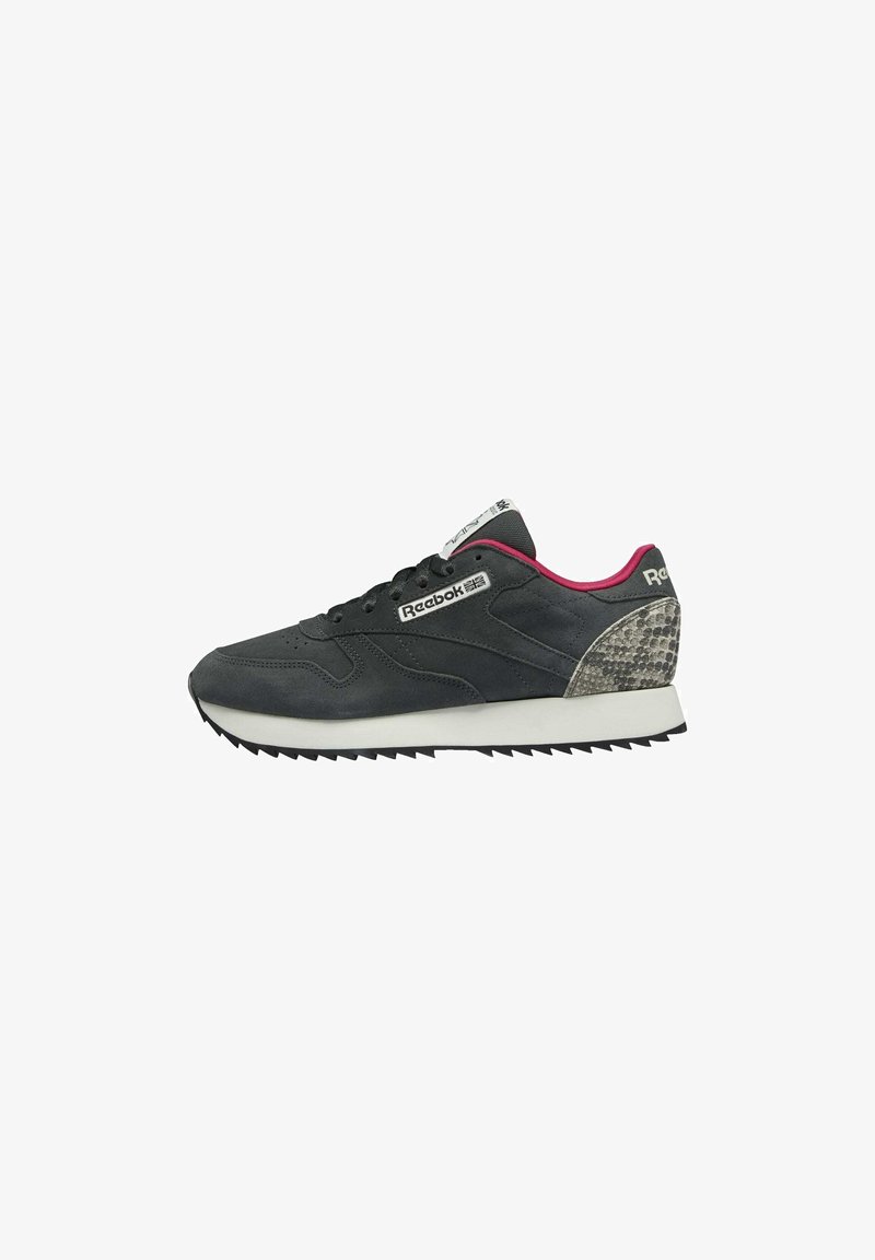 Baskets Reebok noires et grises avec semelle blanche, doublure intérieure rose, motif peau de serpent au talon et logo sur le côté et la languette.