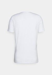T-shirt en coton blanc à manches courtes, col rond et texture lisse et unie. Aucun motif ni graphique visible au dos.
