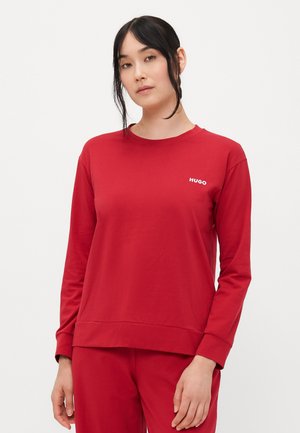 Felpa rossa a maniche lunghe realizzata in tessuto morbido, con scollatura rotonda e logo bianco "HUGO" sul lato sinistro. Design semplice, senza fantasie.