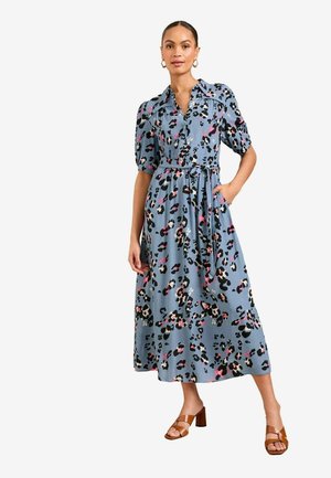 Blue, midi-length dress with a collar, short puff sleeves, and a belt. Features a leopard print in black, pink, and tan. Worn with brown heeled sandals.