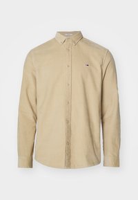 Camicia in corduroy beige con colletto button-down, maniche lunghe e piccolo logo sul petto. Texture morbida, vestibilità regolare.