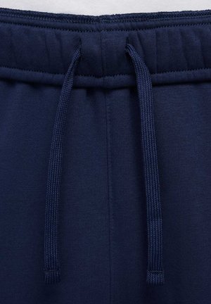 Marineblå joggebukser med snor i taljen, blød tekstur, elastiske manchetter og glat stof med minimale syninger.