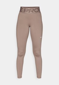 Sportovní legíny vysokého pasu v barvě mauve s širokým páskem s logem a malým bílým znakem Nike na pravém stehně.