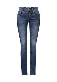 Úzké džíny v tmavě modré denimové barvě, s mírným zvýšeným pasem, pěti kapsami, jemným vyblednutím a kontrastním švem.