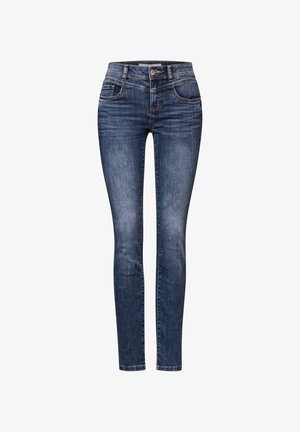 Jean skinny-fit en denim bleu foncé, avec une taille mi-haute, cinq poches, un léger délavage et des coutures contrastées.