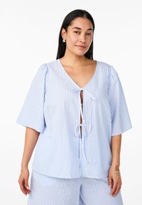 Pale blue and white striped blouse with a deep v-neckline, short puff sleeves, and a front tie closure. Soft texture, light fabric.