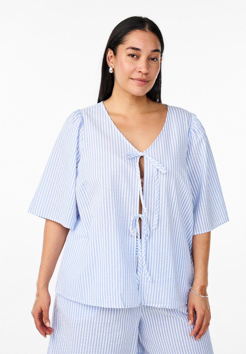 Pale blue and white striped blouse with a deep v-neckline, short puff sleeves, and a front tie closure. Soft texture, light fabric.