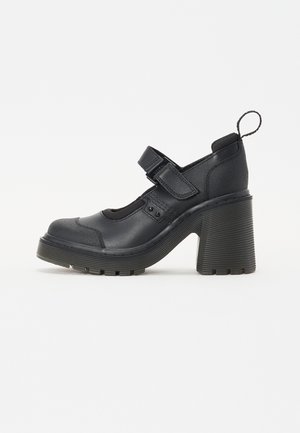 Scarpe con tacco nere, con punta rotonda, cinturino in velcro, tomaia texture e un tacco spesso e rigato per stabilità.